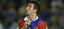 Andrew Johns watches a kick sail over