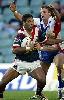 Justin Hodges about to be tackled by Mark Hughes.
