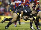 Kurt Gidley makes a tackle.