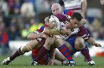 Albert Torrens is tackled.