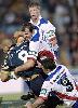 Matt Parsons and Danny Buderus tackle Paul Rauhihi.