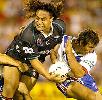 Andrew Johns about to put Joe Galavao on the ground.