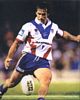 Andrew Johns boots it downfield.