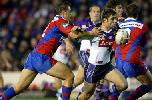 Cameron Smith is tackled by Andrew Price.