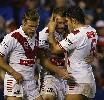 Matt Cooper is congratulated after crossing for the Dragons last try.