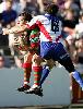 Kurt Gidley makes a flying tackle.