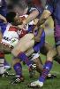 Wes Naiquama is wrestled to the ground.