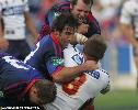 Shane Webcke is tackled by Clint Newton, Andrew Johns and Reegan Tanner.