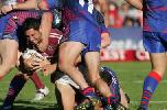 Brent Kite is tackled close to the line.