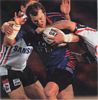 Clint Newton is chopped down by Sydney defence.