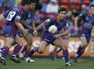 Andrew Johns throws a pass.