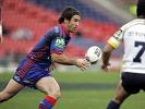 Andrew Johns throws an inside pass.