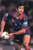 Andrew Johns about to throw a pass.