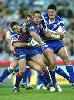Adam Woolnough gets caught by Willie Mason and Braith Anasta ...