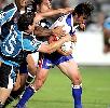 Andrew Johns goes hard against the Cronulla defence.