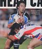 Andrew Johns gets low to tackle Phil Bailey.