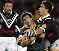 Andrew Johns is caught by Shontayne Hape.