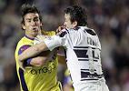 Andrew Johns pushes away from Paul Cooke.