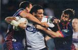 Justin Hodges tries to break free of Clint Newton and Andrew Johns.