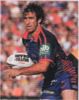 Andrew Johns about to run the ball.
