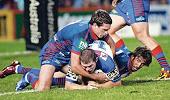Danny Buderus and Andrew Johns take down Andrew Ryan.