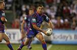 Andrew Johns spins a pass away.