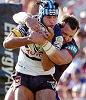 Johnathan Thurston is wrapped up by Clint Newton.