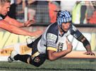 Jonathan Thurston gets around Danny Buderus ...