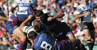 Craig Smith, Steve Simpson and Adam Woolnough all take care of Shane Webcke.