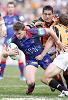 Matthew Gidley is taken to ground.
