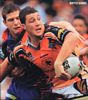 Bryce Gibbs flicks a ball out the back of Riley Brown's tackle.