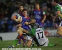 Kurt Gidley is just caught by a Canberra defender.
