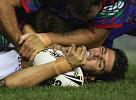 Trent Barrett is turfed by former team-mate Craig Smith.
