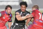 Ruben Wiki makes light work of a Todd Lowrie tackle.