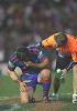 Andrew Johns feels the ill-effects of a boot to the face.