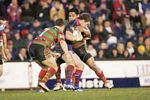 Anthony Quinn is wrapped up by South Sydney defenders ...
