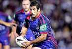 Andrew Johns puts the head down and runs with all his might.