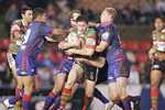 Mark Minichiello is wrapped up by Lowrie, Newton and Tighe.