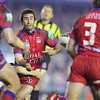 Andrew Johns offloads from a tackle.