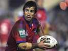 Andrew Johns looks for someone to pass to.