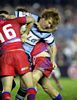 Lance Thompson (anything but bald) is tackled.