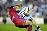 Fullback Brett Kearney is felled.