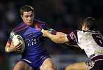 Anthony Quinn tries to wrestle free of a tackler.