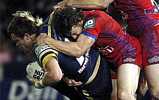 Gavin Cooper is tackled by Kurt Gidley.