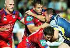 Matthew Scott is driven backwards by Perry and Buderus.