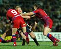 Mitchell Sargent is puched over by Danny Buderus and Kurt Gidley.