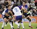 Brian Carney displays some strong defence on New Zealand's David Fa'alogo.