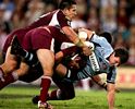 Steve Simpson is driven down by a couple of Queenslanders.