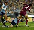 Steve Simpson watches Brett Kimorley tackles Karmichael Hunt, low down.