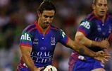 Andrew Johns puts boot to ball.